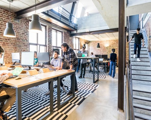 Team members discussing lifestyle content in a modern office