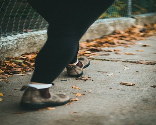 Close up of comfortable walking shoes on a city sidewalk